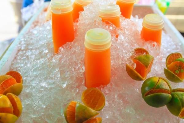 Chill juice bottles with ice cubes
