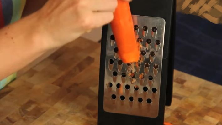 Grating carrots with a cheese grater