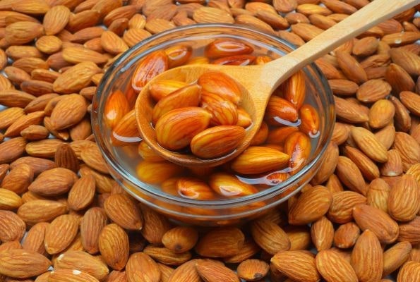 put handfuls of soaked almond into a juicer with water