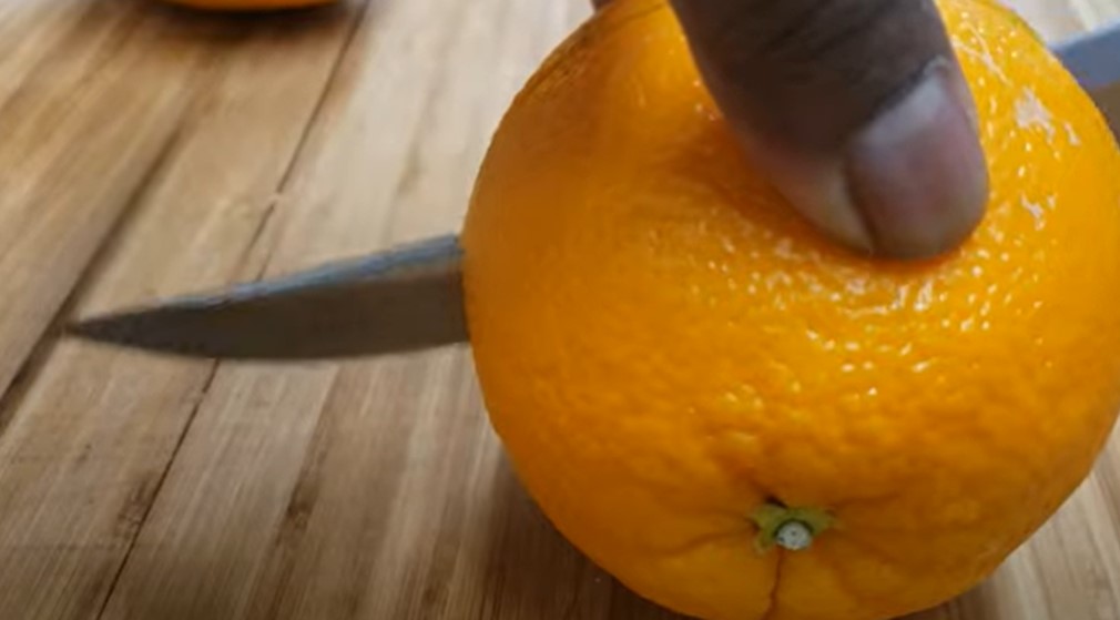 Cut the orange into half for juicing